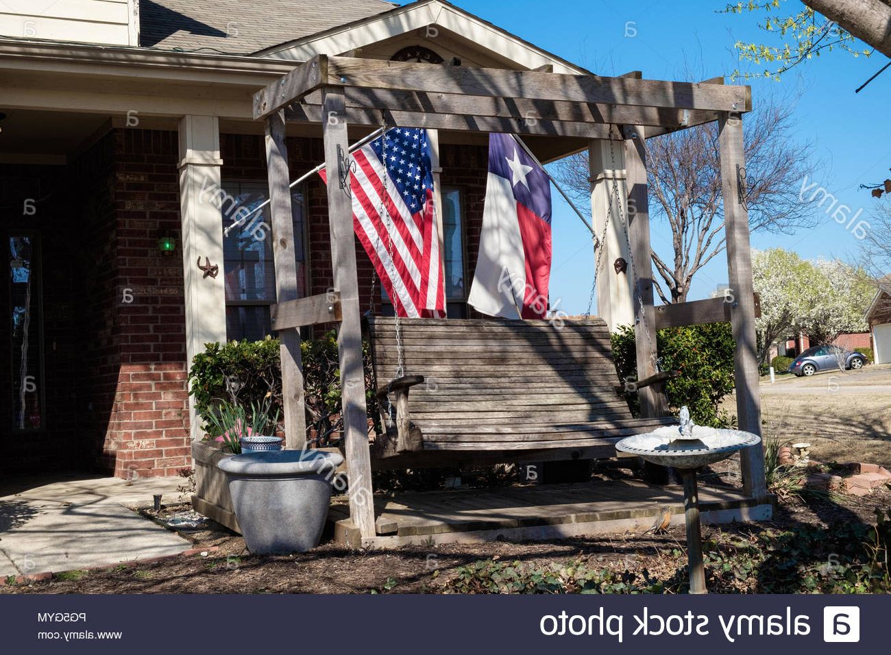 Texas Flag & American Flag On Extended Flag Poles Outside In Well Liked American Flag Porch Swings (View 12 of 25)
